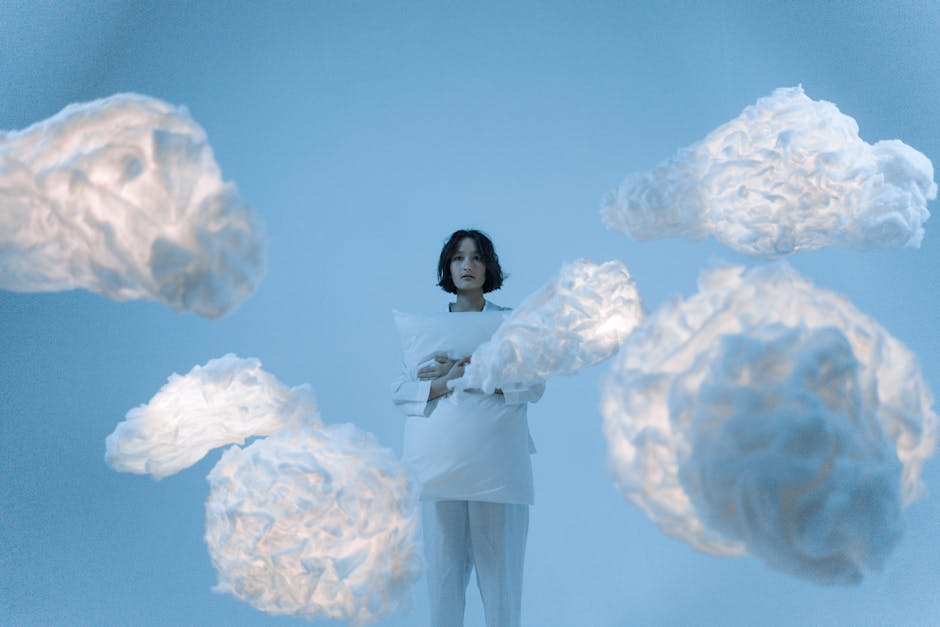 A serene portrait of an Asian woman surrounded by illuminated clouds in a conceptual, dreamy setting.