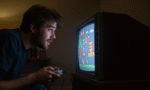 nostalgic gamer playing on an old TV screen with pixel art visuals horizontal format